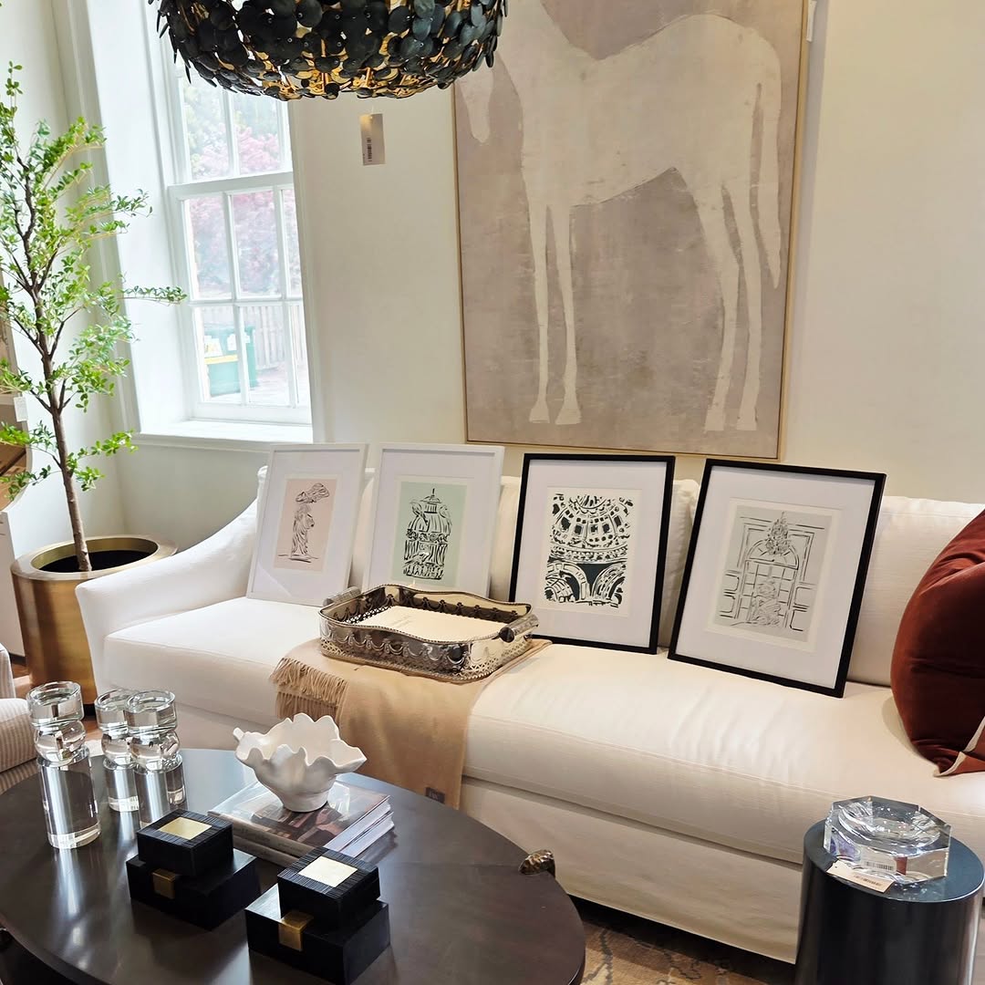 Framed prints arranged on a sofa