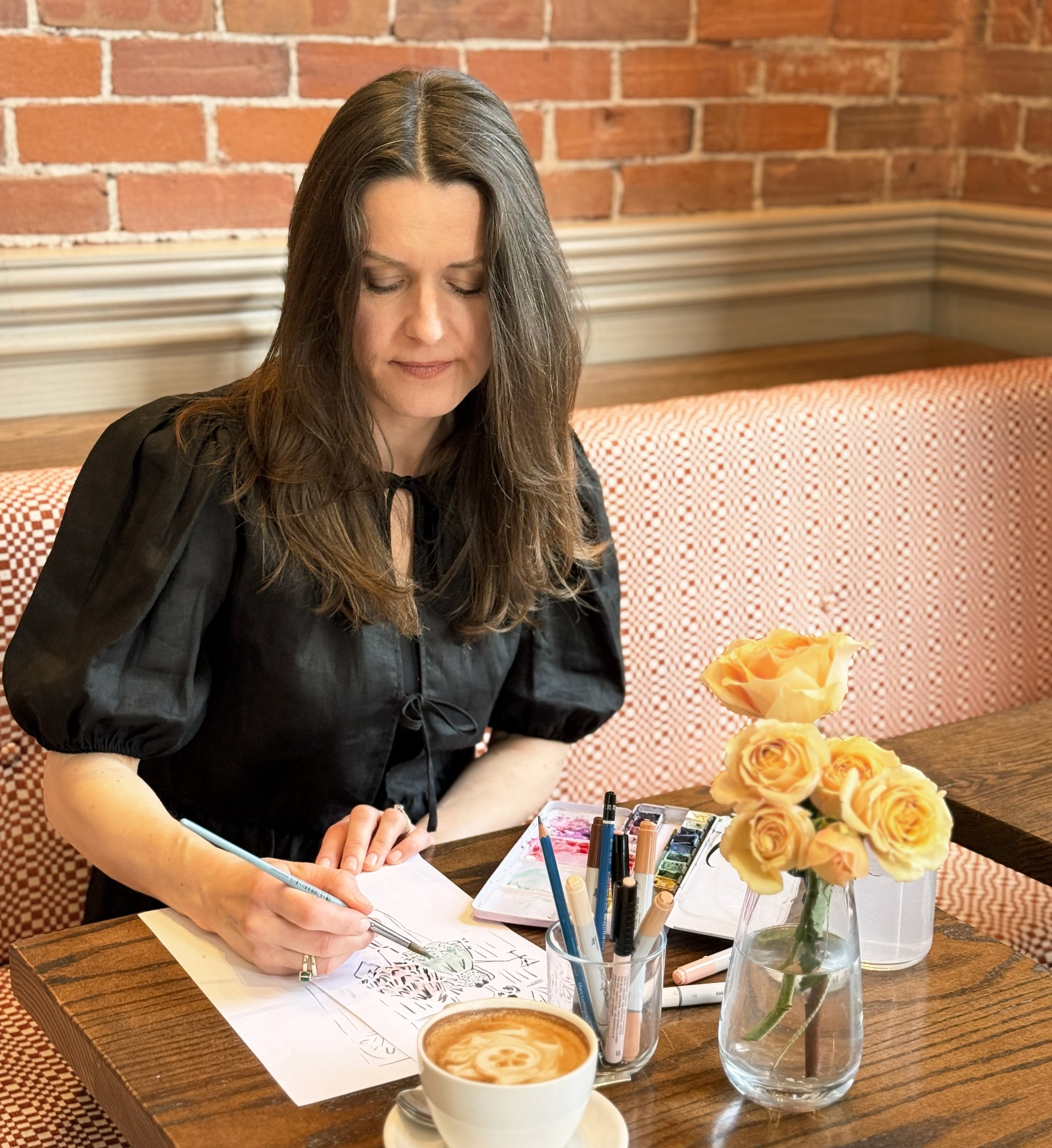 Berta Biondic illustrating live at a café